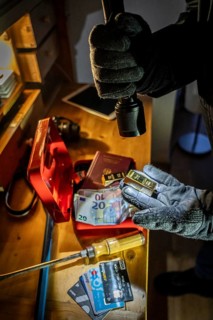 Symbolic image of a burglary, perpetrator has broken into a flat from the garden side and is