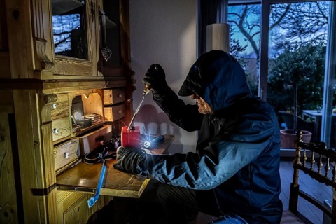 Symbolic image of a burglary, perpetrator has broken into a flat from the garden side and is