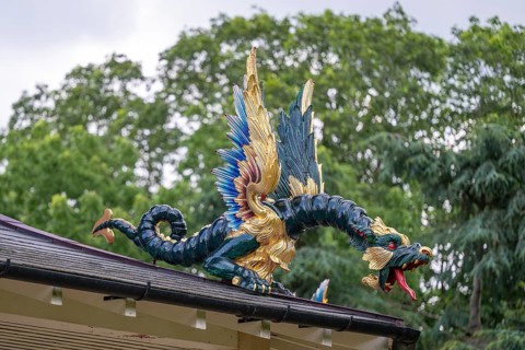 Close-up of a gold-blue-red painted dragon statue, historic large pagoda, Royal Botanic Gardens