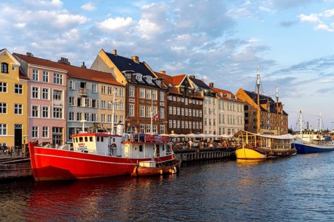 Colourful houses, restaurants and historic ships on the Nyhavn canal and harbour, Copenhagen,