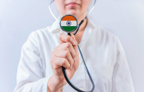 Doctor holding stethoscope with India flag. National Health System of India