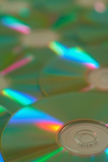 Several CD-ROMs with rainbow effect on the surface, close-up