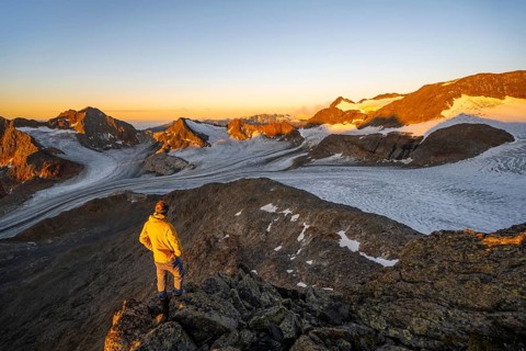 Mountaineer at the summit of the Becher, view of high mountain landscape with glacier