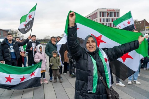 Syrian woman celebrate the end of the Assad regime after the change of power in Syria at a rally on