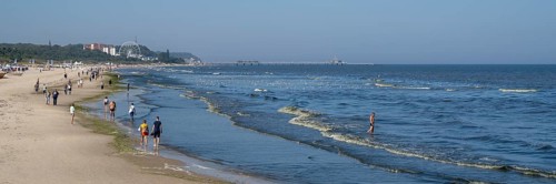 Tourists on the beach, behind the pier of Heringsdorf, Ahlbeck, Usedom Island, Baltic Sea,