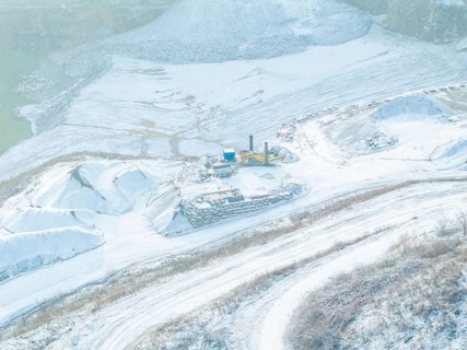 Detailed view of a snow-covered area in a quarry with excavators, Nagold, Black Forest, Germany,