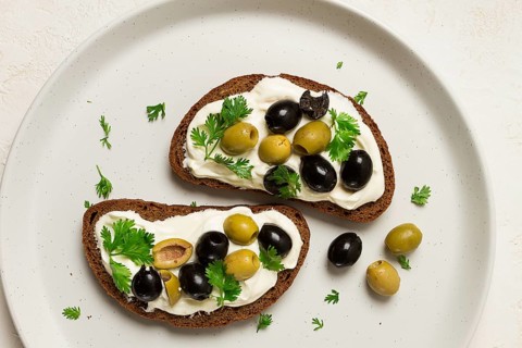 Breakfast, sandwiches, with cream cheese, olives, top view