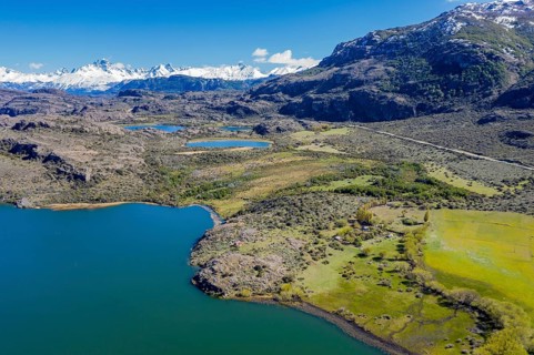 Farm at a lake near Puerto Ingeniero Ibanez, Mt. Cerro Castillo in the back, aerial view,