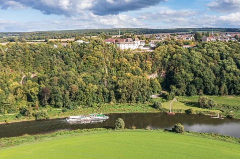 Aerial view of excursion boat on the Weser river passing castle Fürstenberg, Weserbergland,