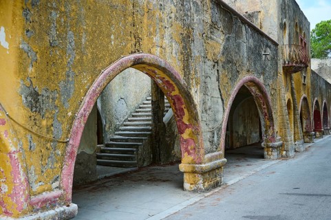 An old wall accompanied by arches showing signs of historical decay and deterioration, Italian