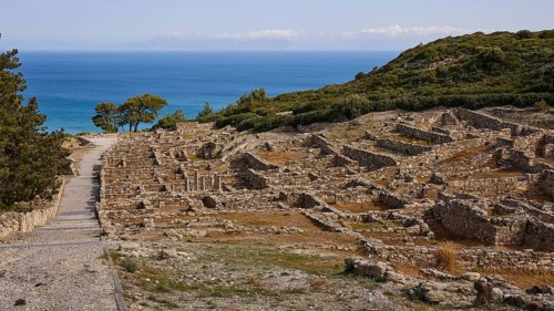 Ancient ruins on a hill with a view of the sea and a path in the foreground, Hellenistic houses,