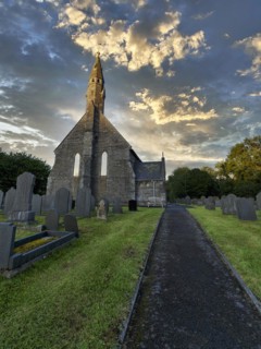 All Saints Church, gravestones in the churchyard, cemetery, evening sky, Llangorwen, Aberystwyth,