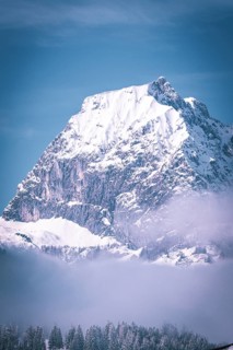 Prominent snowy mountain peak against a clear blue sky, Kaisergebierge, The Mountain Doctor, Elmau,