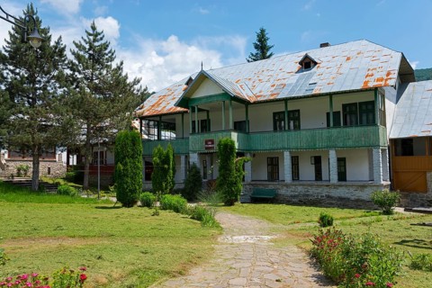 Two-storey monastery building in greenery with trees and a relaxing ambience, House of the Pilgrim,