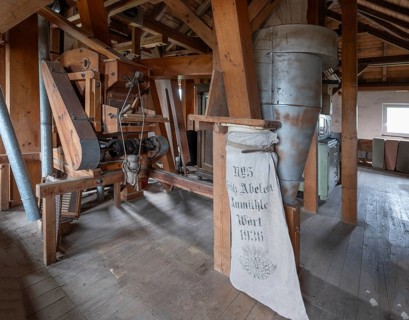 Historic plansifter in a former corn mill, old flour sack from 1936 on the right, Bavaria, Germany,