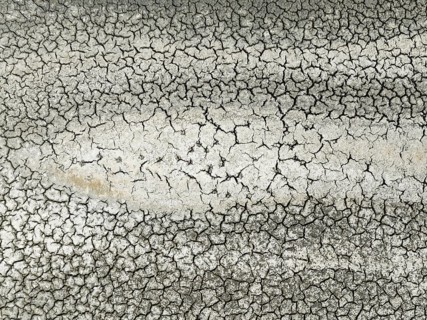 Cracked earth in the marshland near Sanlúcar de Barrameda. Aerial view. Drone shot. Cádiz province,