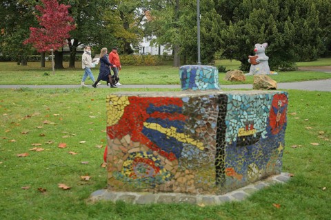 Pedestrian in the park with mouse figure reading a book, bookworm, literature, sculpture, public