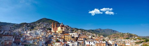 Mexico, Scenic panoramic view of Taxco historic center with colonial houses on the hills and famous