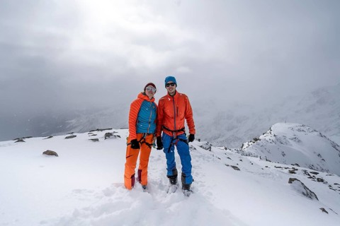 Two ski tourers, couple on the summit of the Köllkuppe or Cima Marmota, snow-covered mountain