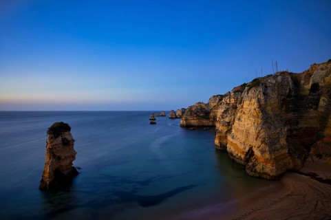 Coloured cliffs and rocks in front of sunrise on the beach, Praia da Dona Ana, Lagos, cliffs,