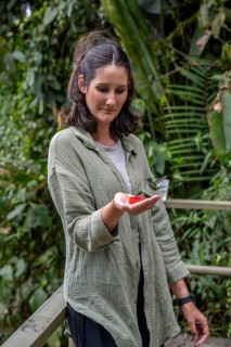 Young woman feeding hummingbirds, Mindo Forest Reserve, Mindo, Ecuador, Mindo Forest Reserve,