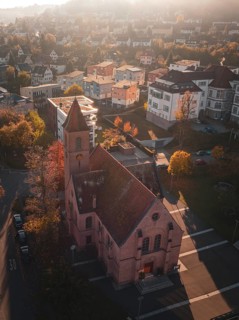 Church in urban surroundings in autumn weather and oblique sunlight, Nagold, Black Forest, Germany,