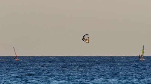 Wingfoiller, A windsurfer performs a jump in the air, Windsurfer, Meltemi windsurfing spot, Devils