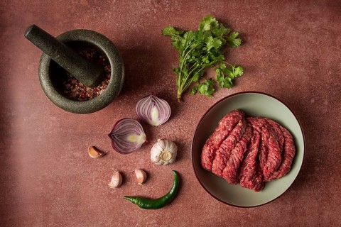 Fresh minced meat, raw, with spices and ingredients. on the table, preparation, top view