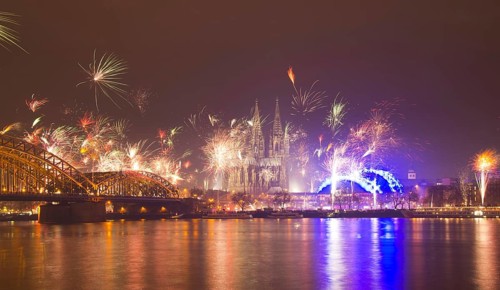 New Year's Eve fireworks, Hohenzollernbruecke with cathedral and Musical Dome, Rheinufer, Cologne,