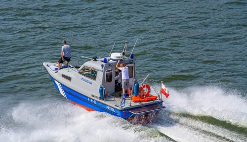 Police boat at full speed on the river Swina in Swinoujscie, Western Pomerania, Poland, Eastern