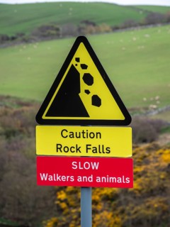 Single track road at St. Abbs head, warning sign to be aware of walkers and rock fall, uk, United