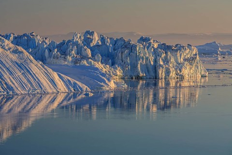 Icebergs and ice floes reflected in the water, summer, midnight sun, Jakobshavn glacier and ice