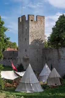 Camp in front of historic city wall with defence defence tower, Medieval Week, Hanseatic City of
