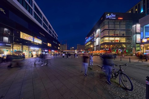 Rathausstraße with shops and cinema complex Cine Star in the evening, Berlin, capital city,