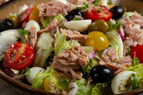 Salad with canned tuna, vegetable salad with quail eggs, lettuce, red onion, cherry tomatoes,