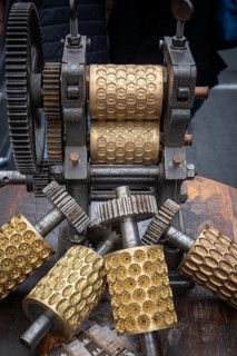 Old embossing machine with profiled metal rollers, machine parts, embossing rollers, brass matrices