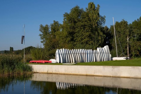 Surfboards standing next to each other in a stand on the Achterwasser, Ückeritz, Usedom Island,