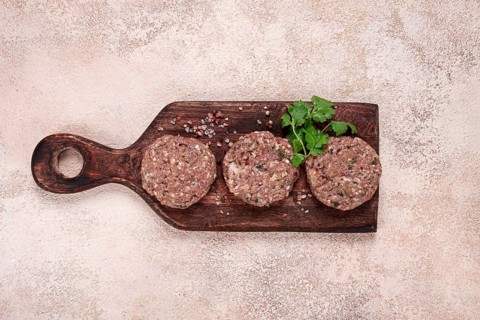 Raw cutlets, minced meat, on a chopping board, homemade, top view, no people