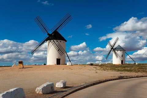 Two windmills on a hill under a blue sky with clouds, Campo de Criptana, Ciudad Real province,