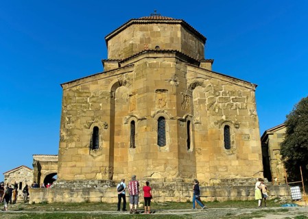 Tourists look at the east façade of the Jvari Church of the Cross, Jvari Monastery, UNESCO World