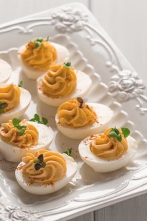 Boiled eggs stuffed with yolk with mayonnaise, on a white plate, selective focus, blurry, close-up,