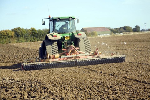 Tractor harrowing field, Parham, Suffolk, England, United Kingdom, Europe