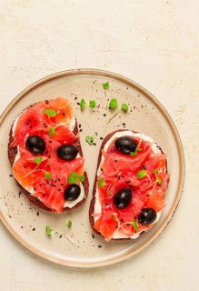 Sandwiches with red fish, cream cheese, olives and microgreens, breakfast