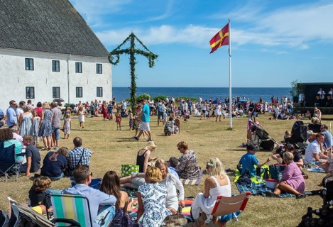 Traditional midsummer celebration with dancing around the maypole at Smygehuk, Smygehamn,