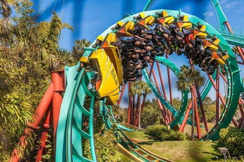 Kumba roller coaster corkscrew seen through safety netting at Busch Gardens in Tampa, Florida, USA,