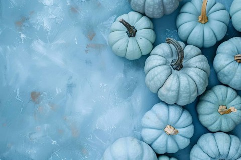 Pastel blue decorative pumpkins on side of blue background with copy sapce. Generative Ai, AI