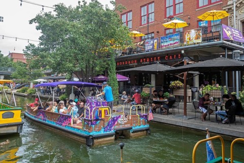 Oklahoma City, Oklahoma - Tourists ride a canal boat on the Bricktown Canal in Bricktown, a popular