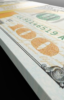 Ten thousand dollar stack of one hundred dollar bills close-up abstact.