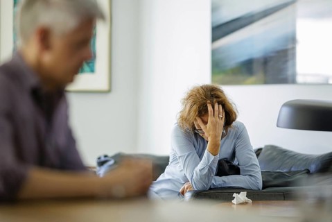 Symbolic photo on the subject of problems in a partnership. An older woman and an older man sitting