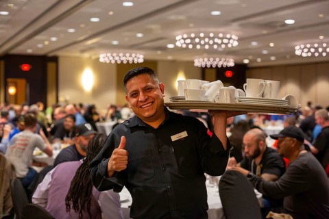 Chicago, Illinois - A worker clears dishes during a banquet at the Crowne Plaza Hotel.